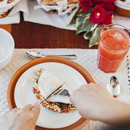 Prato de tapioca com suco de frutas servido na mesa de café da manhã